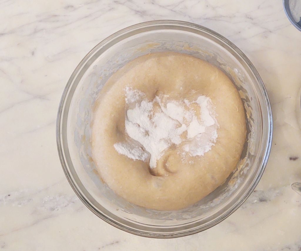 adding baking powder, soda and salt to sourdough cinnamon roll dough