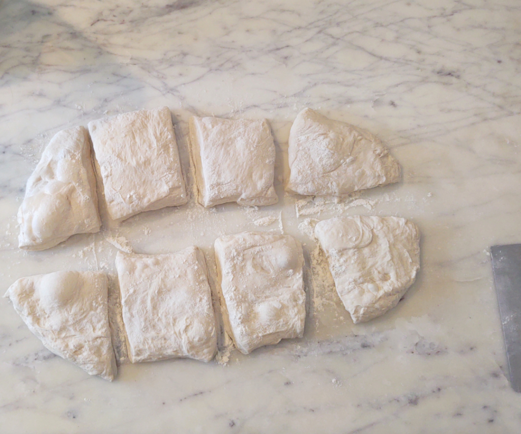 cutting sourdough ciabatta into 8 pieaced