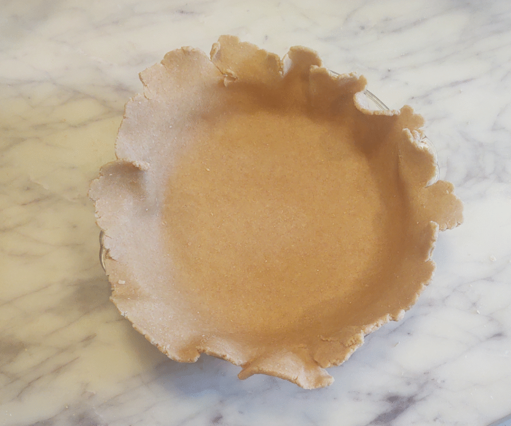 placing pie dough onto pie plate