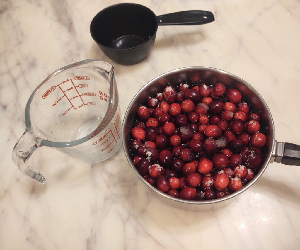 add water to cranberries and sugar
