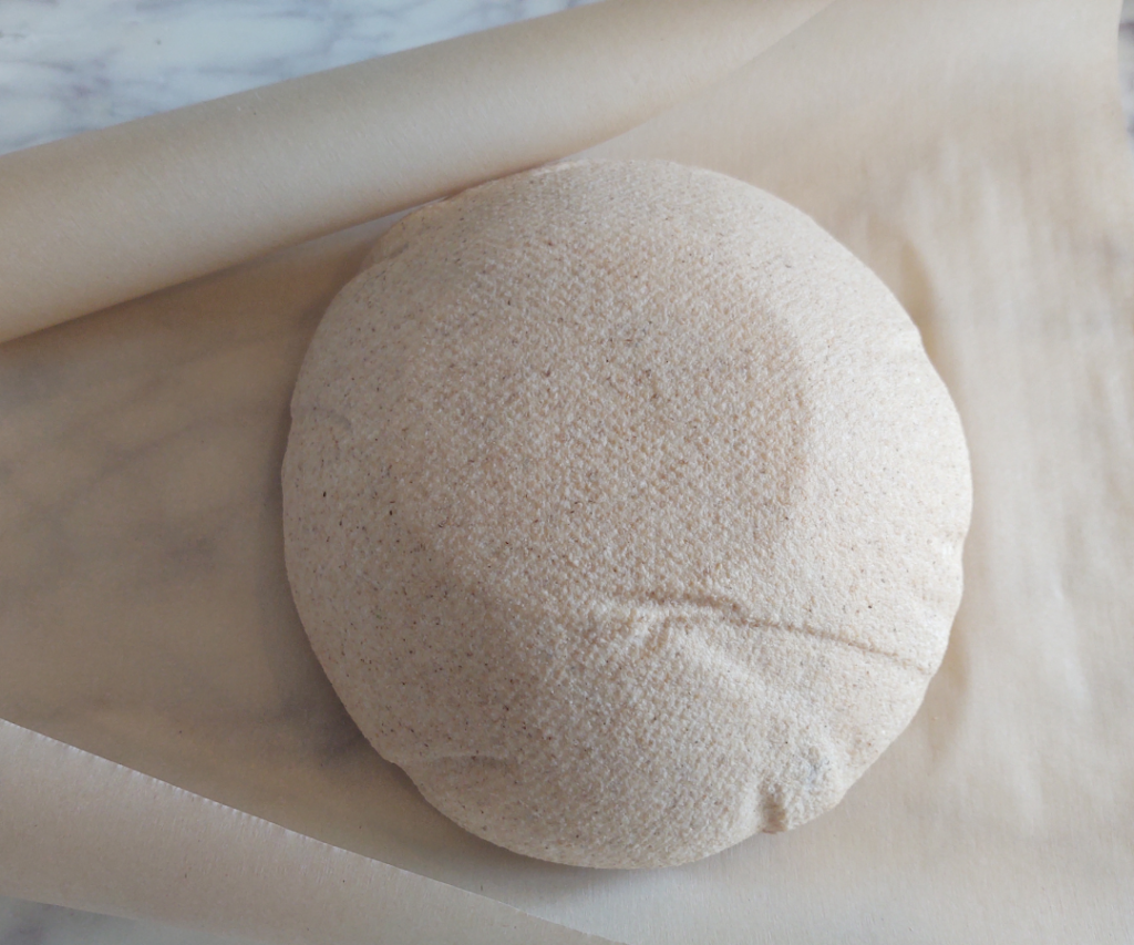 sourdough ball on parchment paper