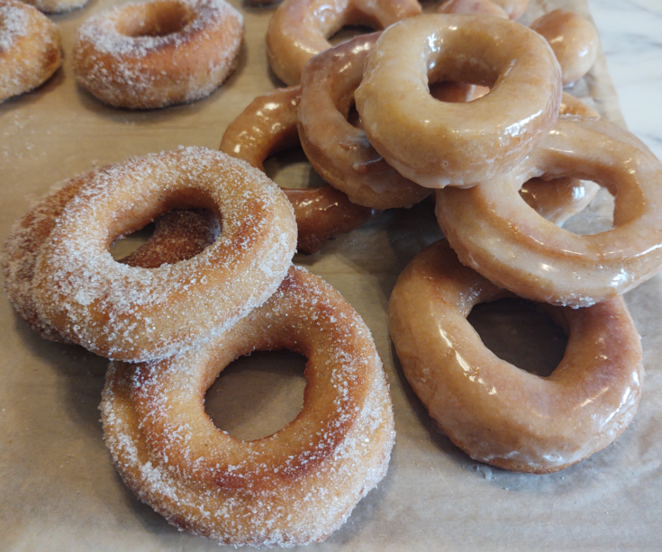 stacked freshly milled donuts