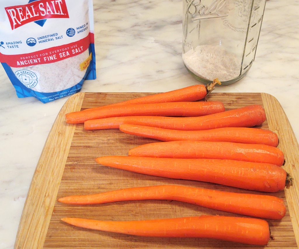 peeled carrots with salt in jar
