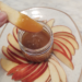 dipping apple in caramel sauce made with honey